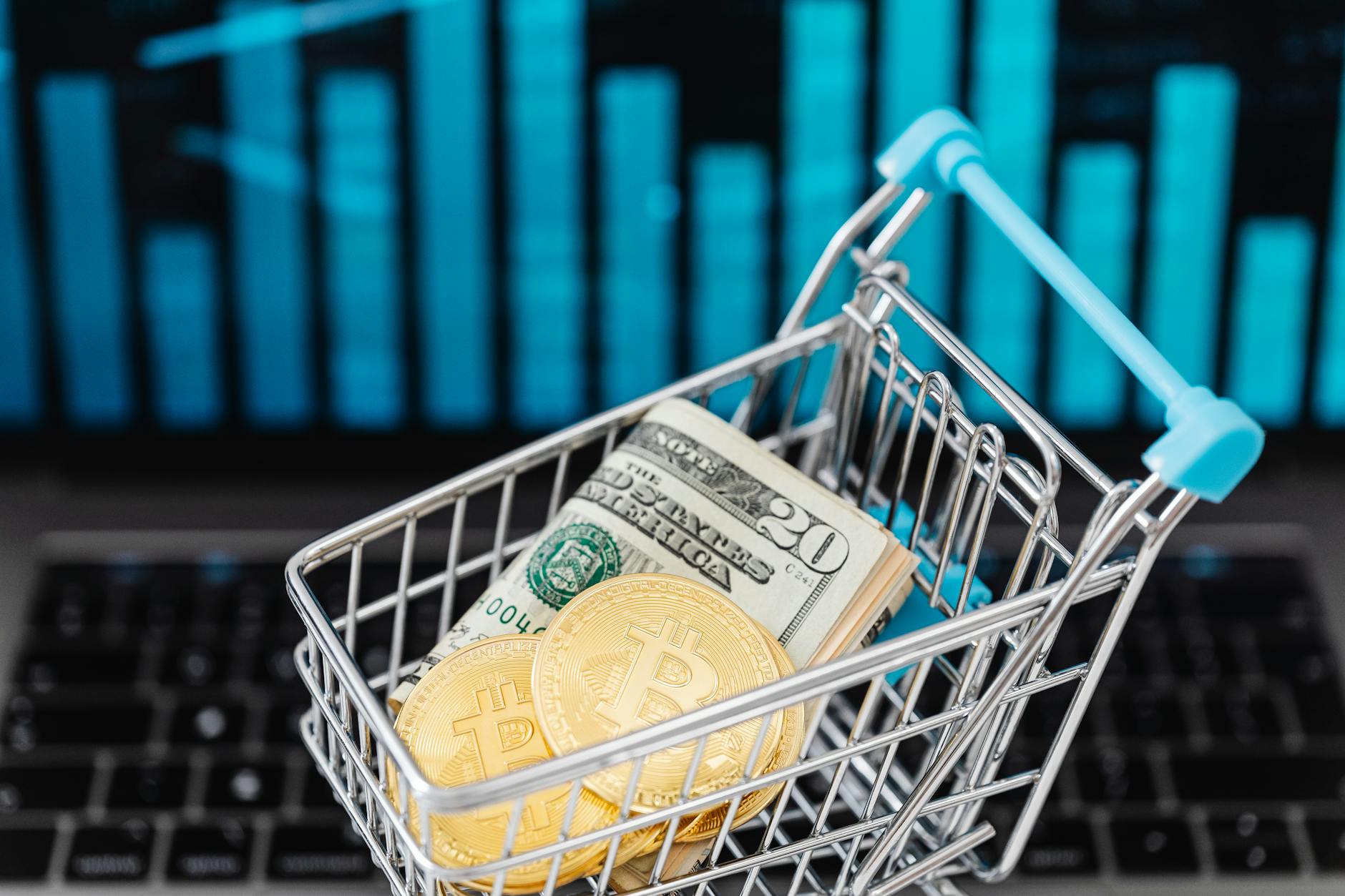 gold bitcoin coins and cash in a miniature shopping cart