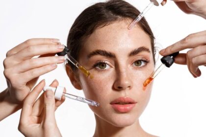 skincare picture showing a lady with hands applying serum on her face